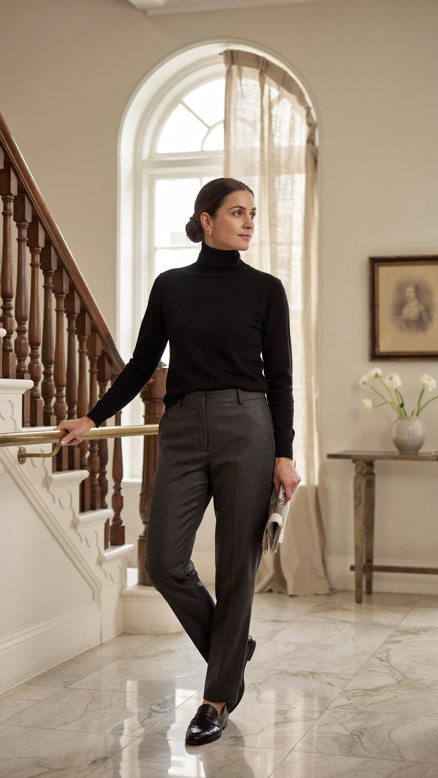 Woman wearing a black turtleneck and wool trousers creating a sleek old money outfit