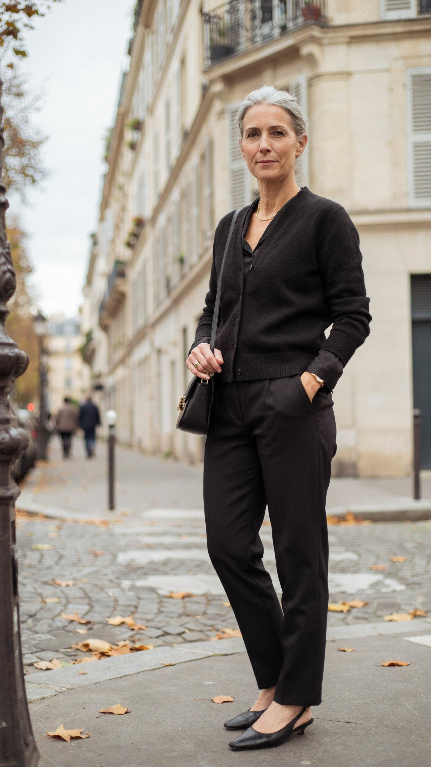 All black old money outfit featuring a fitted cardigan and pleated trousers with timeless styling