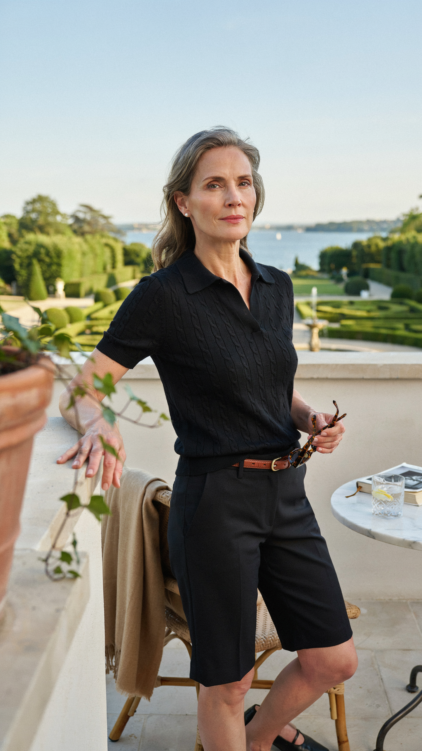 Sophisticated black polo knit outfit with tailored shorts and old money styling